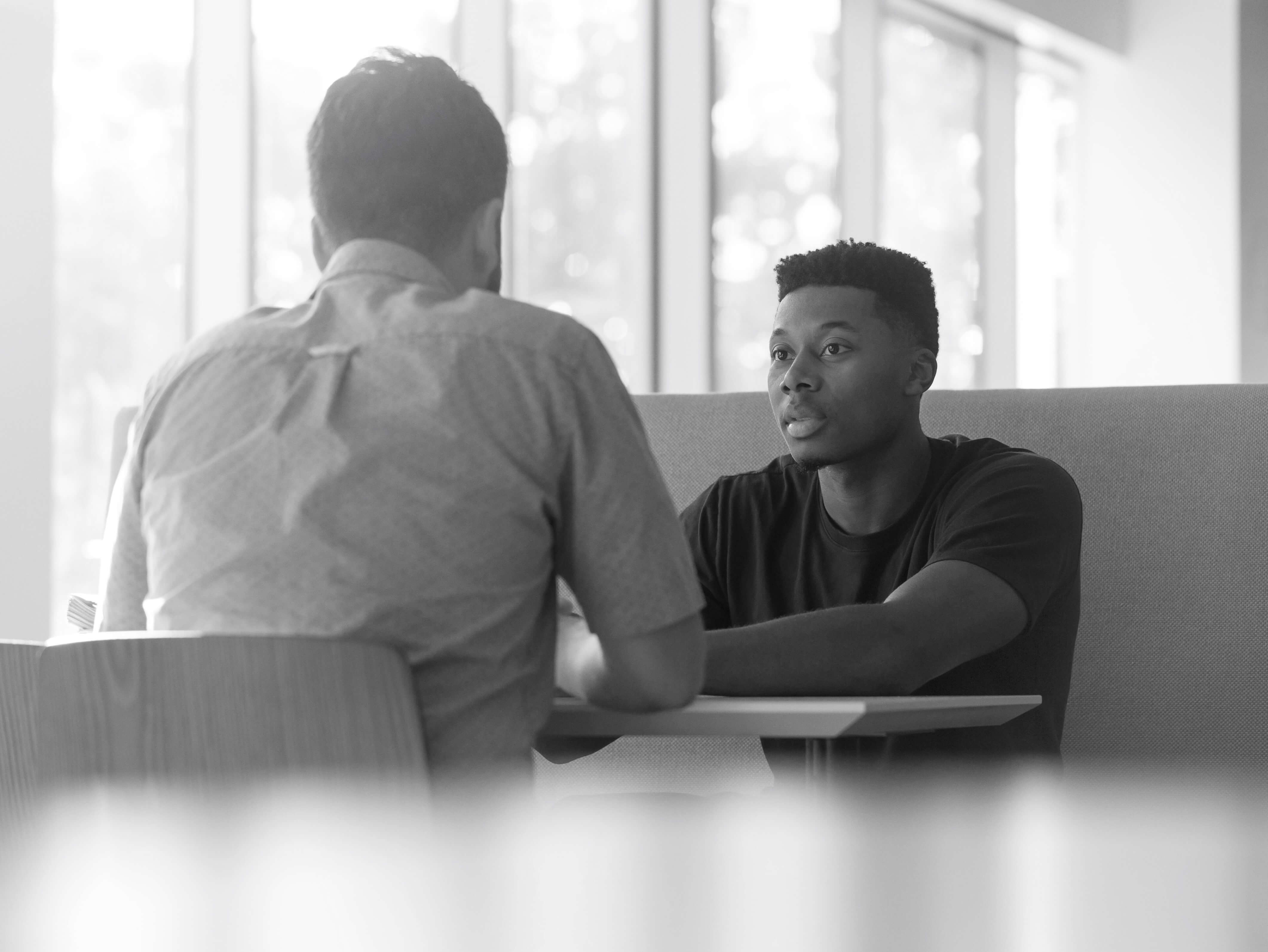 Two people talking at a table